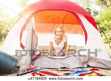 Stock Photo - Portrait of woman sitting in tent. Fotosearch