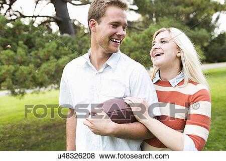 Stock Photo - Portrait of young couple in park. Fotosearch