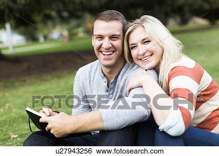 Portrait of young couple in park View Large Photo Image Stock Photograph - Portrait of young couple in park. Fotosearch
