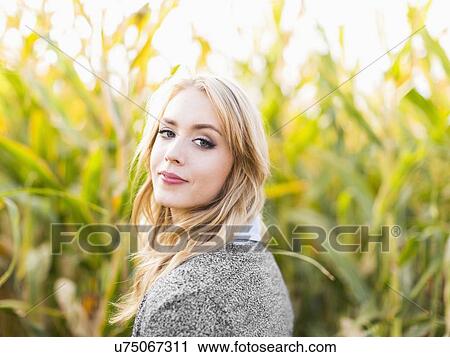 Portrait of young woman in corn field View Large Photo Image Stock Image - Portrait of young woman in corn field. Fotosearch