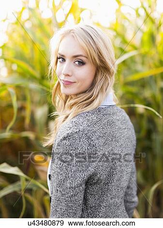 Portrait of young woman in corn field View Large Photo Image Stock Photo - Portrait of young woman in corn field. Fotosearch