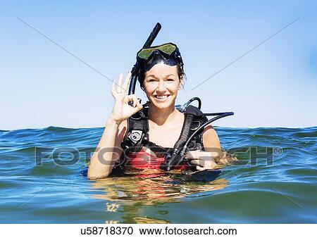 Portrait of young woman scuba-diving in sea View Large Photo Image Stock Image - Portrait of young woman scuba-diving in sea. Fotosearch