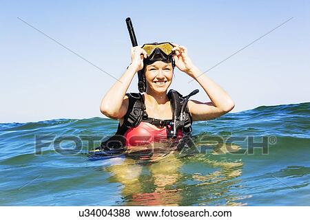 Stock Photo - Portrait of young woman scuba-diving in sea. Fotosearch