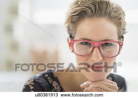Portrait of young woman wearing glasses View Large Photo Image Stock Image - Portrait of young woman wearing glasses. Fotosearch