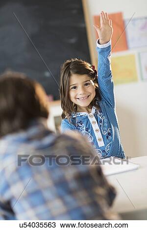 Pupils (6-7) learning in classroom, Girl (6-7) raising hand View Large Photo Image Stock Image - Pupils (6-7) learning in classroom, Girl (6-7) raising hand. Fotosearch