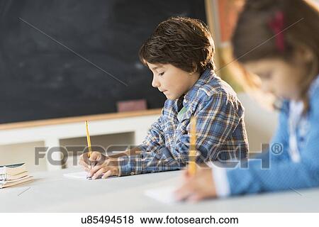 Pupils (6-7) learning in classroom View Large Photo Image Stock Photo - Pupils (6-7) learning in classroom. Fotosearch