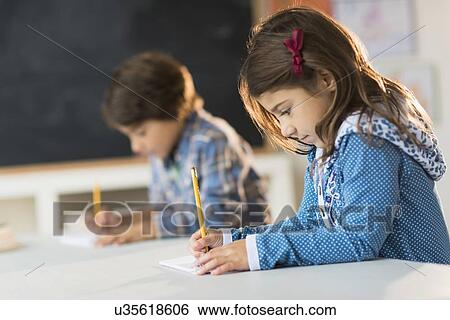 Pupils (6-7) learning in classroom View Large Photo Image Stock Photograph - Pupils (6-7) learning in classroom. Fotosearch