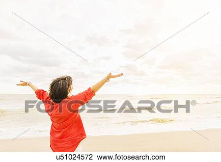 Rear view of woman looking at ocean View Large Photo Image Stock Image - Rear view of woman looking at ocean. Fotosearch