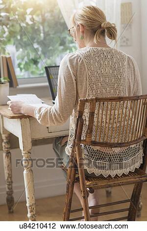 Rear view of woman working with laptop View Large Photo Image Stock Image - Rear view of woman working with laptop. Fotosearch