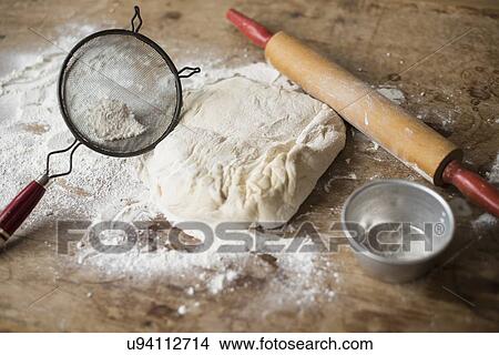 Rolling pin, Strainer and dough on kitchen counter View Large Photo Image Picture - Rolling pin, Strainer and dough on kitchen counter. Fotosearch