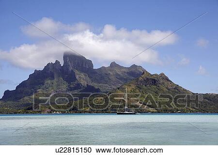 Stock Image - Sailboat with islands at background. Fotosearch