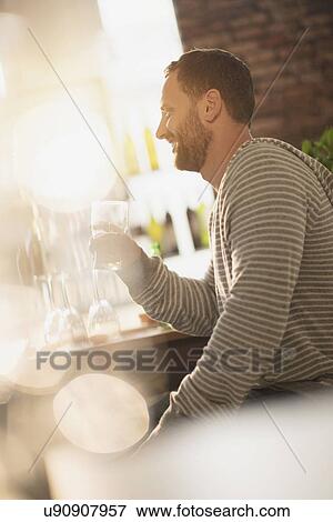 Side view of man having drink in bar View Large Photo Image Stock Photo - Side view of man having drink in bar. Fotosearch