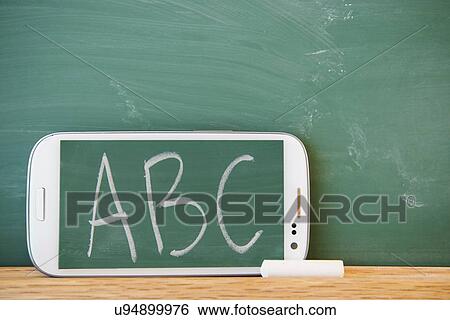 Smartphone leaning against chalkboard with ABC letters displayed View Large Photo Image Stock Photograph - Smartphone leaning against chalkboard with ABC letters displayed. Fotosearch