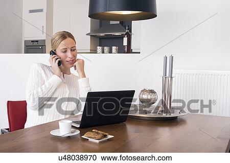 Smiling woman using laptop at home View Large Photo Image Stock Image - Smiling woman using laptop at home. Fotosearch