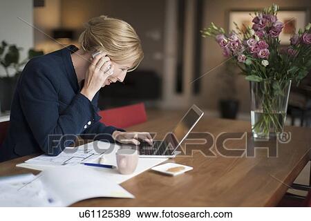 Smiling woman using laptop View Large Photo Image Stock Photo - Smiling woman using laptop. Fotosearch