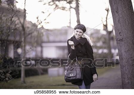 Stock Photography - Smiling woman walking in park. Fotosearch