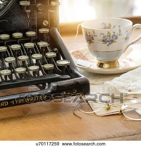 Studio shot of antique typewriter with teacup and eyeglasses View Large Photo Image Stock Photo - Studio shot of antique typewriter with teacup and eyeglasses. Fotosearch