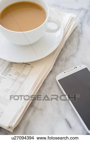 Studio shot of coffee cup, newspaper and smart phone View Large Photo Image Picture - Studio shot of coffee cup, newspaper and smart phone. Fotosearch