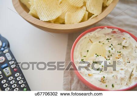 Stock Image - Studio shot of crisps and onion dip. Fotosearch