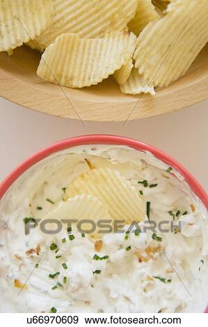 Stock Photo - Studio shot of crisps and onion dip. Fotosearch