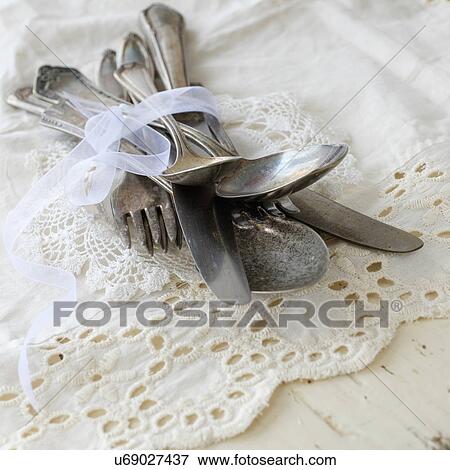 Stock Photo - Studio shot of cutlery on lace cloth. Fotosearch