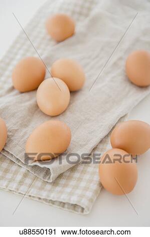 Stock Image - Studio shot of eggs on dishcloth. Fotosearch