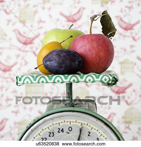 Studio shot of fruits on weight scale View Large Photo Image Stock Photo - Studio shot of fruits on weight scale. Fotosearch