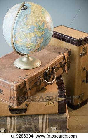 Studio shot of globe on suitcases View Large Photo Image Picture - Studio shot of globe on suitcases. Fotosearch