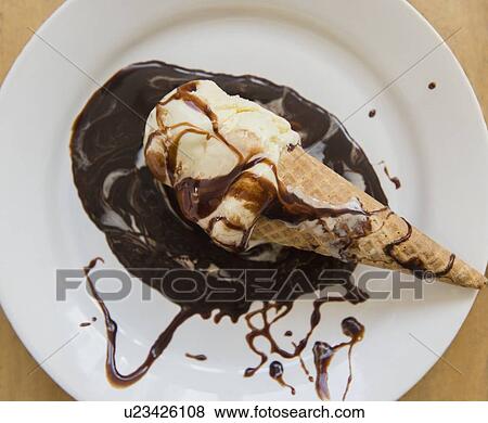 Studio shot of ice cream cone on plate with chocolate sauce View Large Photo Image Stock Photo - Studio shot of ice cream cone on plate with chocolate sauce. Fotosearch