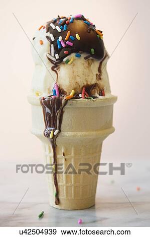 Studio shot of ice cream cone with chocolate sauce View Large Photo Image Stock Photo - Studio shot of ice cream cone with chocolate sauce. Fotosearch