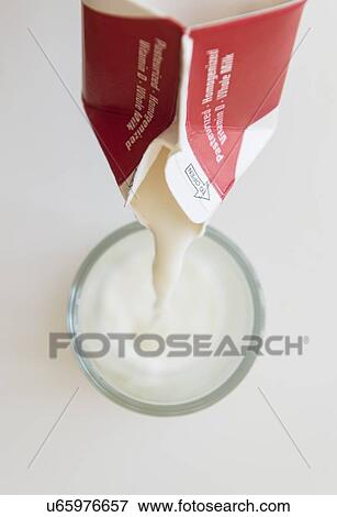 Studio shot of milk pouring into glass View Large Photo Image Stock Photo - Studio shot of milk pouring into glass. Fotosearch
