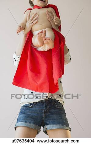 Picture - Studio shot of mother holding baby daughter (18-23 months). Fotosearch