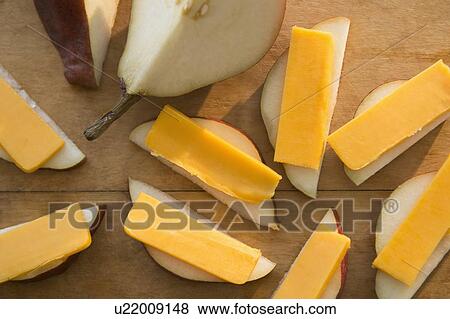 Stock Photo - Studio shot of pear slices with cheddar cheese. Fotosearch