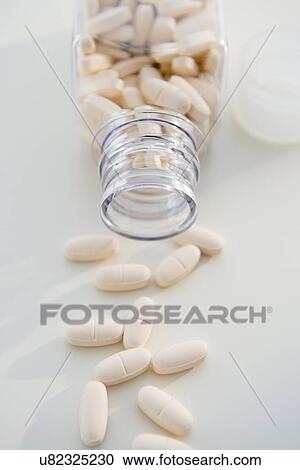 Stock Image - Studio shot of pills in bottle. Fotosearch