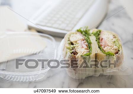 Stock Photo - Studio shot of sandwich in box and computer keyboard. Fotosearch