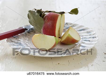 Studio shot of sliced apple on plate View Large Photo Image Stock Photography - Studio shot of sliced apple on plate. Fotosearch