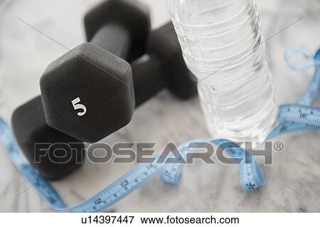 Studio shot of water bottle, measuring tape and weights View Large Photo Image Stock Photo - Studio shot of water bottle, measuring tape and weights. Fotosearch