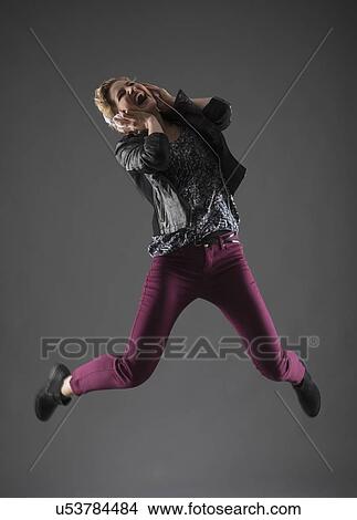 Studio shot of woman jumping View Large Photo Image Picture - Studio shot of woman jumping. Fotosearch