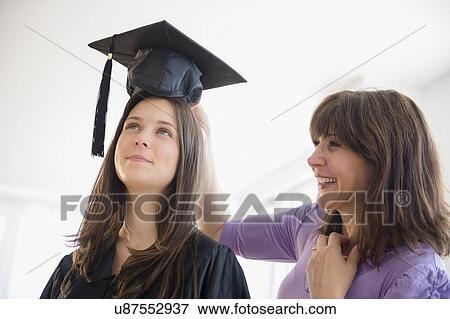 Teenage girl (14-15) getting ready for graduation ceremony View Large Photo Image Stock Photo - Teenage girl (14-15) getting ready for graduation ceremony. Fotosearch