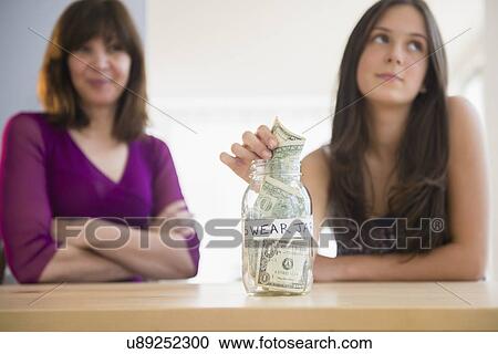 Teenage girl (14-15) putting money in swear jar View Large Photo Image Stock Image - Teenage girl (14-15) putting money in swear jar. Fotosearch
