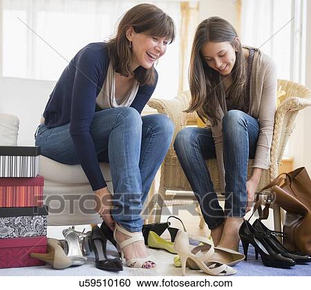 Teenage Girl 14 15 Sitting With Her Mom And Trying On High Heels