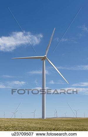 Stock Photo - Wind turbines at green field. Fotosearch