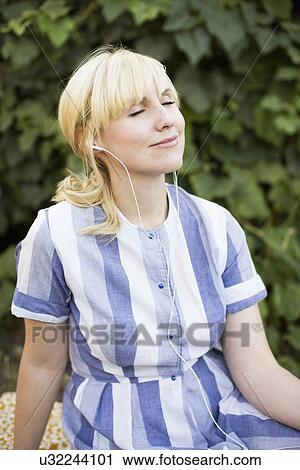 Woman contemplating in garden View Large Photo Image Stock Image - Woman contemplating in garden. Fotosearch