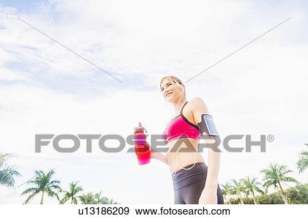 Woman drinking water from bottle View Large Photo Image Stock Photo - Woman drinking water from bottle. Fotosearch