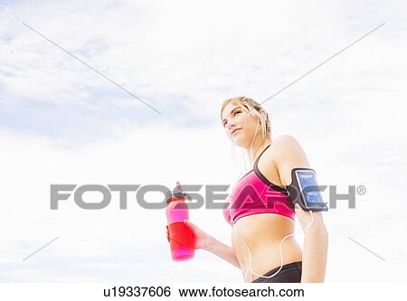 Woman drinking water from bottle View Large Photo Image Stock Photograph - Woman drinking water from bottle. Fotosearch
