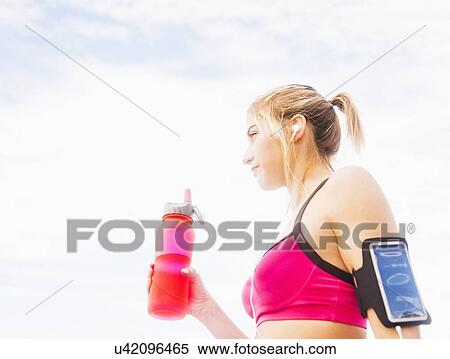 Woman drinking water from bottle View Large Photo Image Stock Photography - Woman drinking water from bottle. Fotosearch