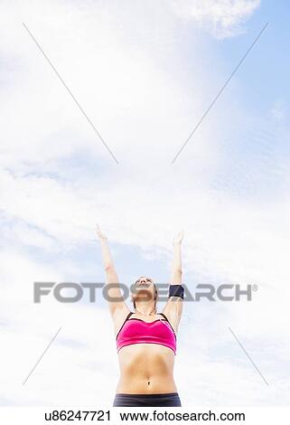 Stock Image - Woman exercising outdoors. Fotosearch