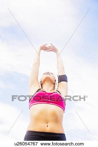 Woman exercising outdoors View Large Photo Image Stock Photo - Woman exercising outdoors. Fotosearch
