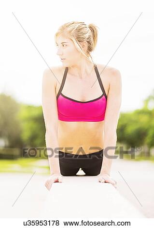 Stock Photo - Woman exercising outdoors. Fotosearch