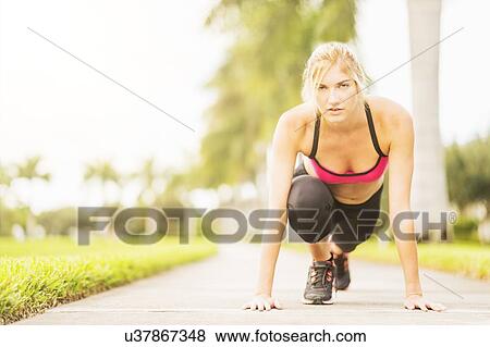 Woman exercising outdoors View Large Photo Image Stock Photo - Woman exercising outdoors. Fotosearch